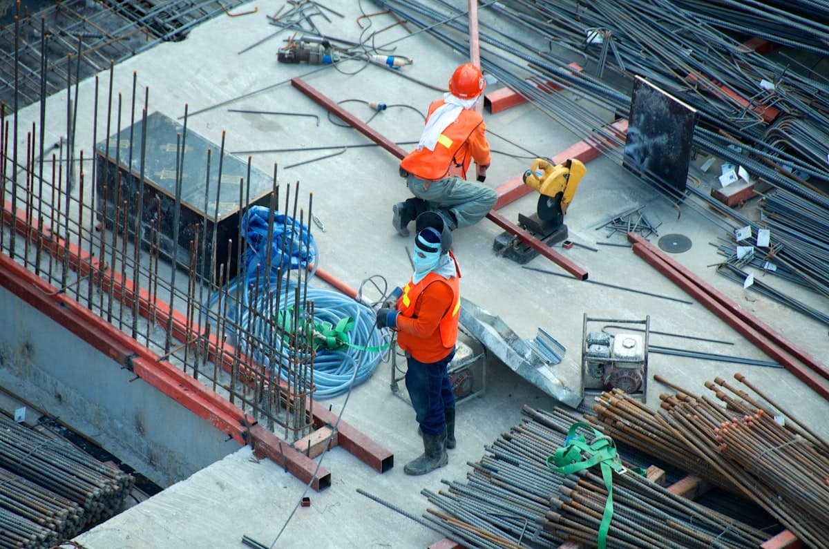 Construction crew managing material installation on a building site