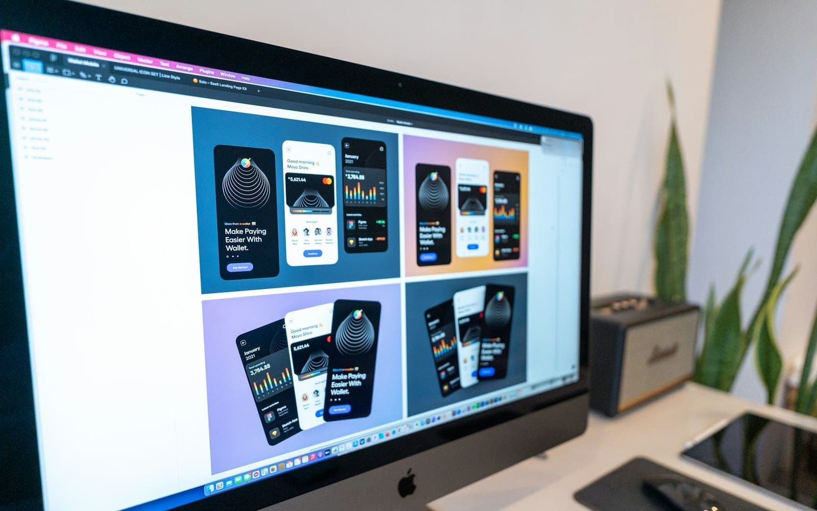 Designer's workstation with a large monitor and design tools on the desk