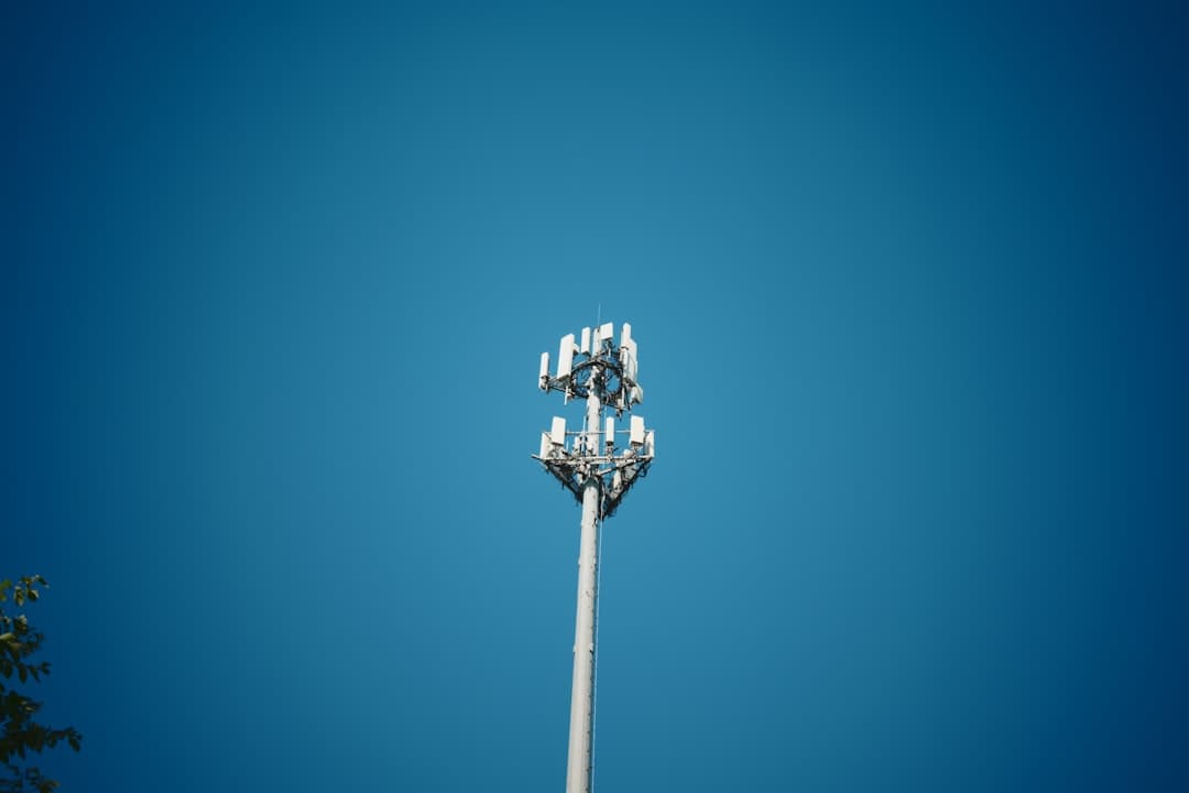 Tall cellular radio tower against a clear sky