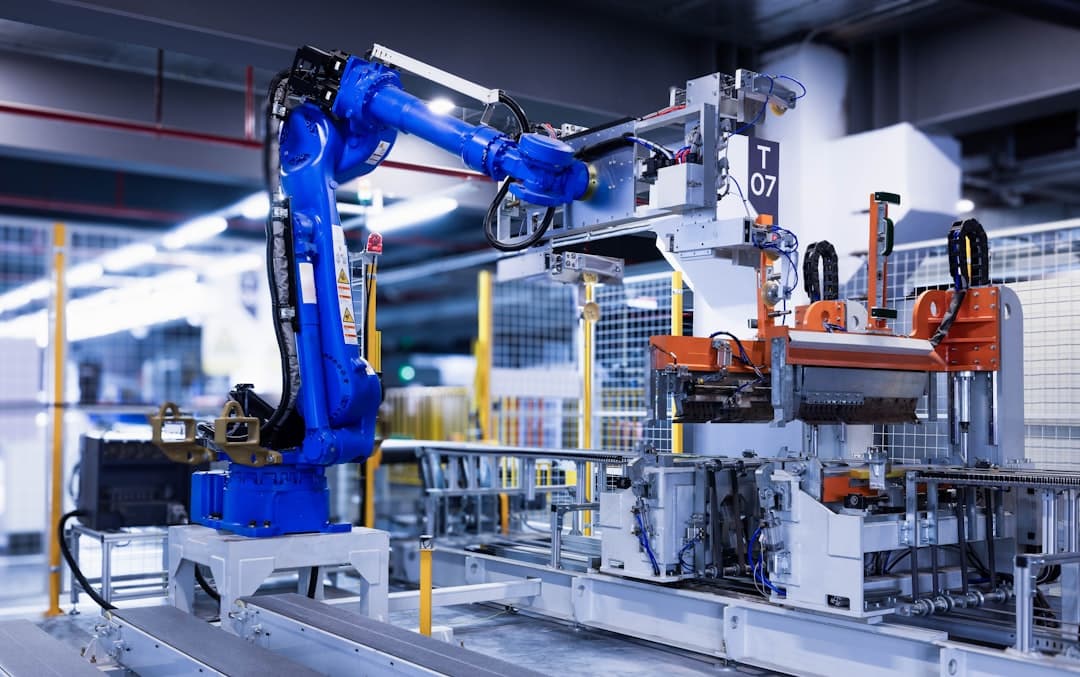 Blue industrial robot arm operating on a factory automation line