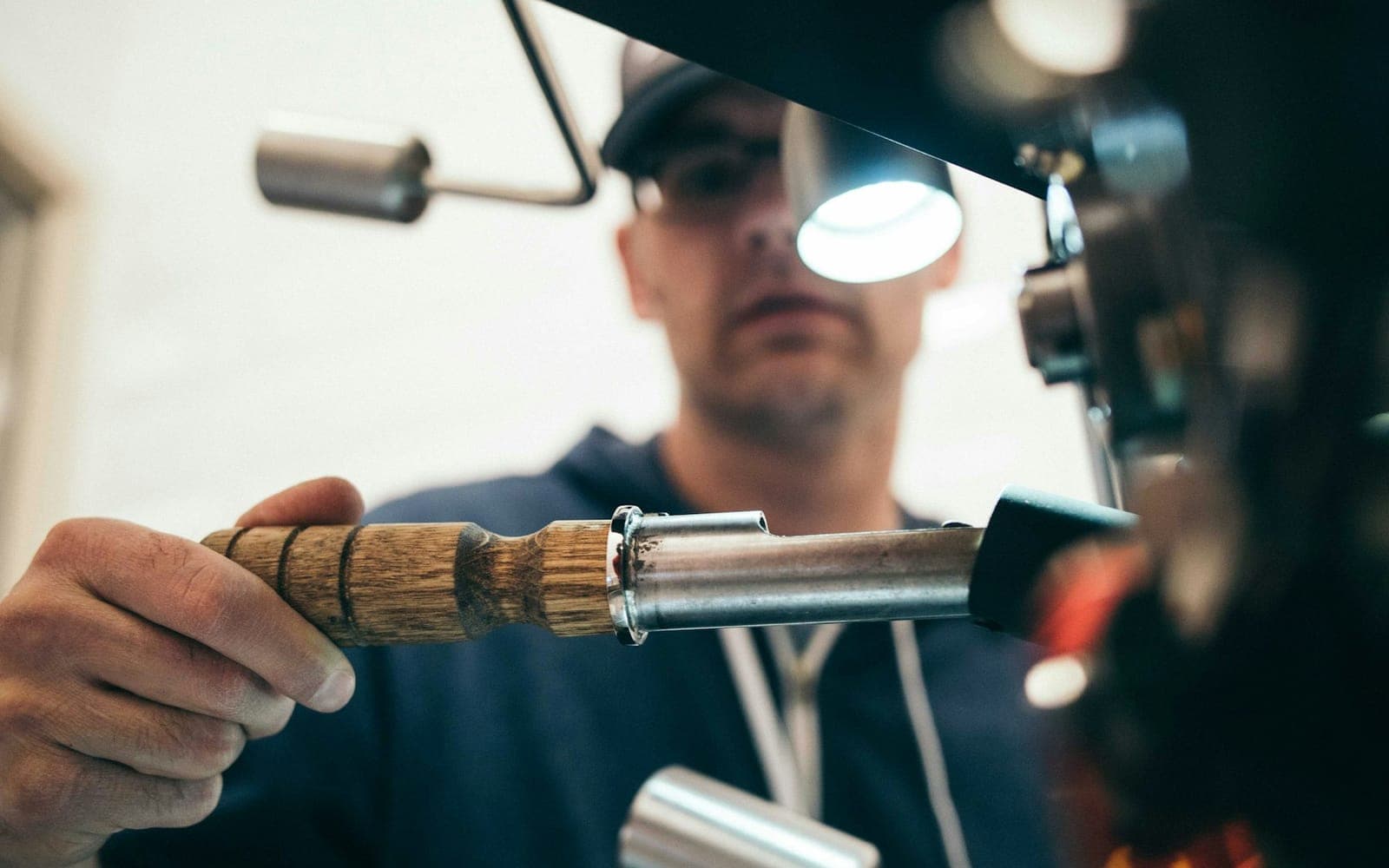 Hands operating industrial machinery in an automation training environment