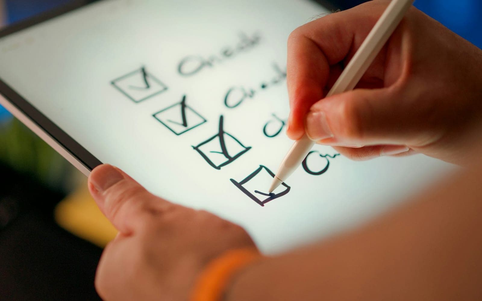 Hand marking completed items off a checklist