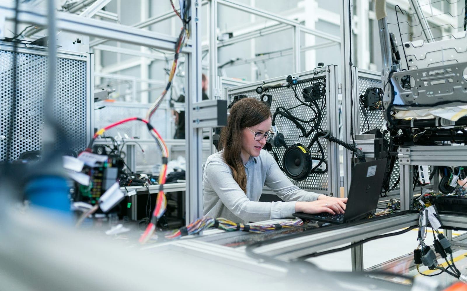 Technician diagnosing industrial equipment with tools in hand