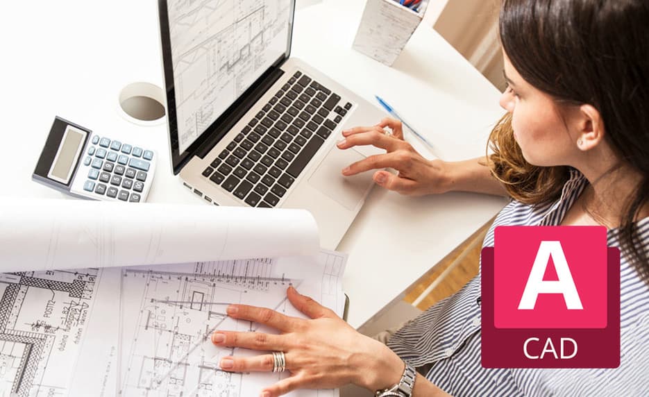 Engineer reviewing CAD floor plans on laptop with AutoCAD branding