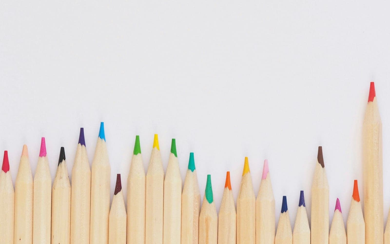 Row of coloured pencils ready for digital image and colour work