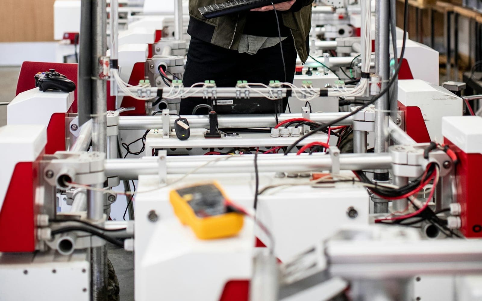 Engineer programming industrial automation hardware at a wired control station