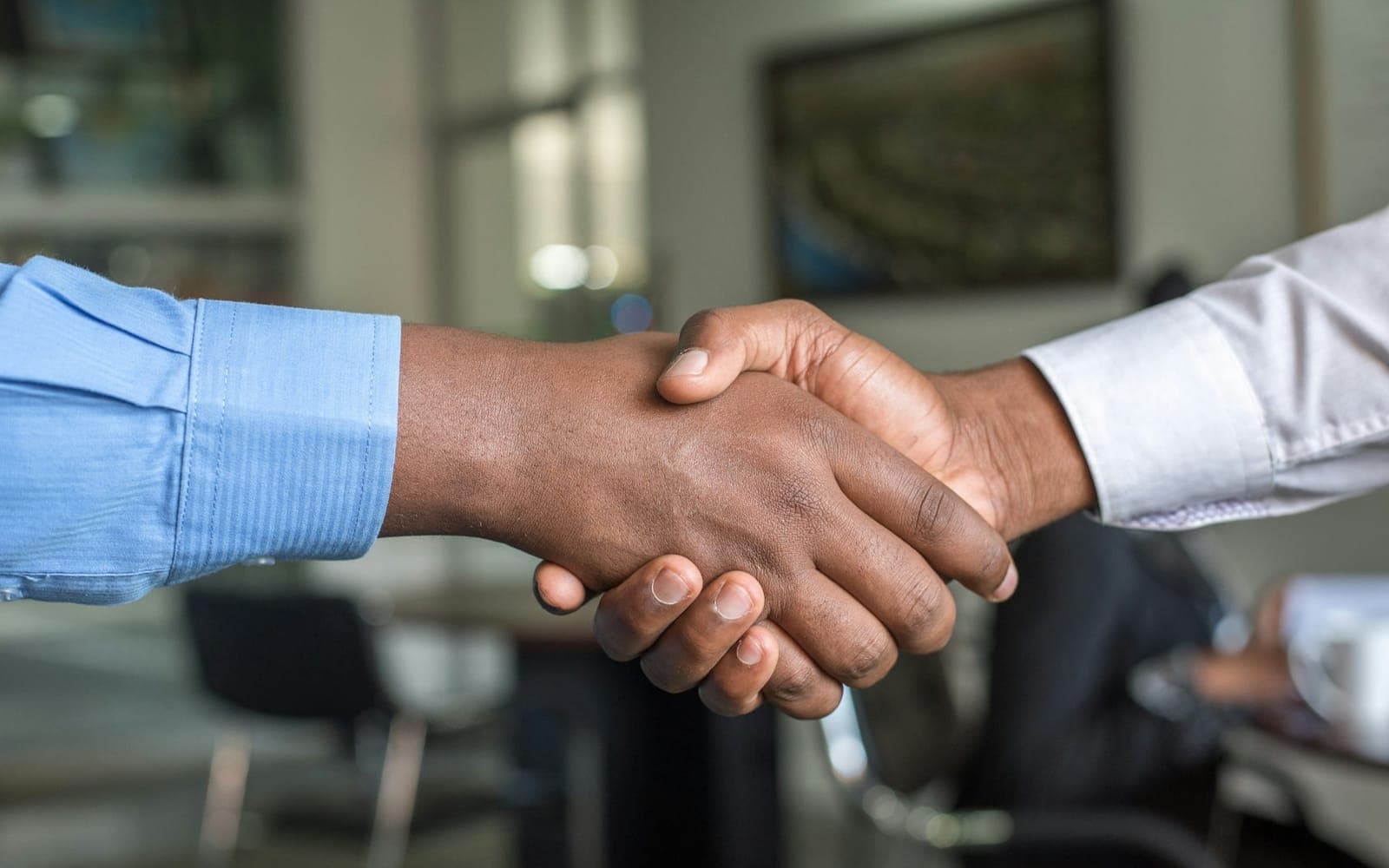 Two professionals shaking hands after a partnership meeting