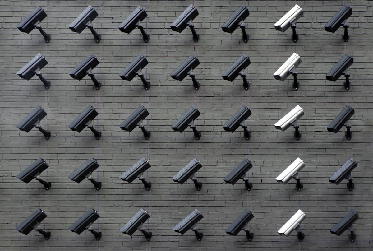 Network operations and IP CCTV monitoring room with multi-screen video feeds