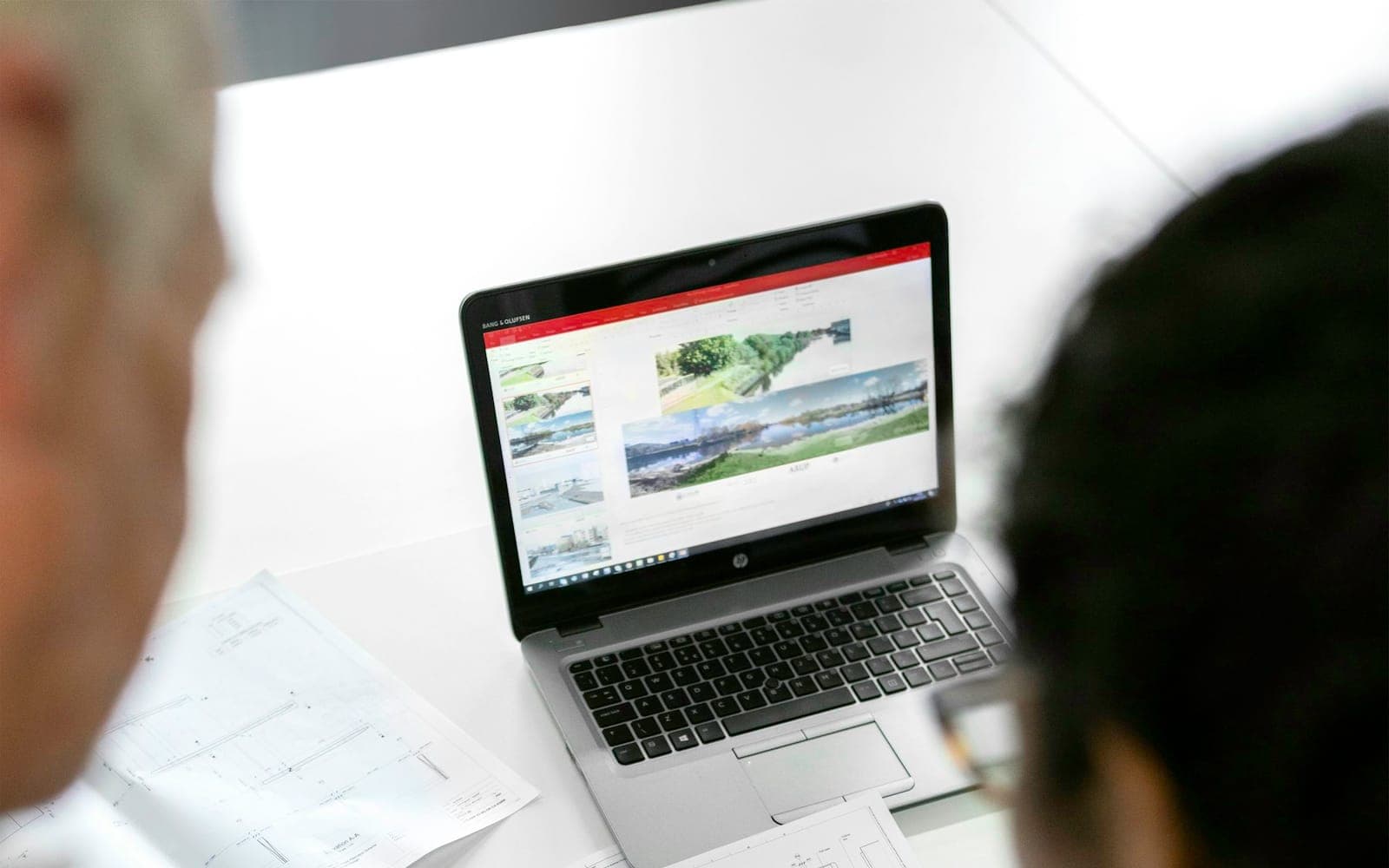 Team reviewing digital process plans in a modern office