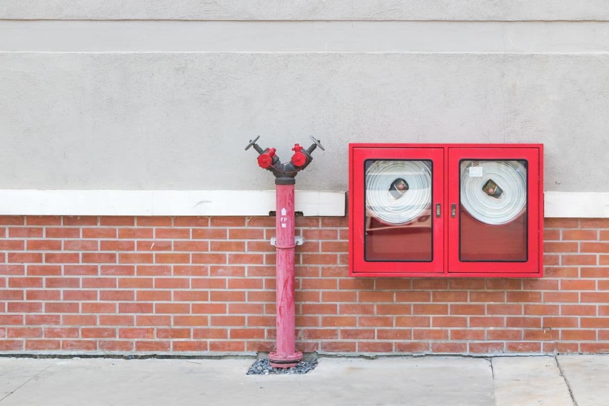 Firefighters with fire fighting equipment and high pressure water