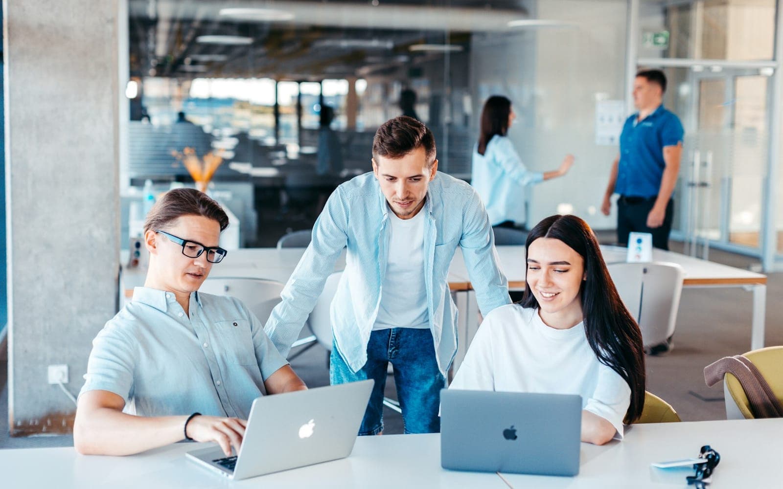 Colleagues collaborating on shared documents on a laptop