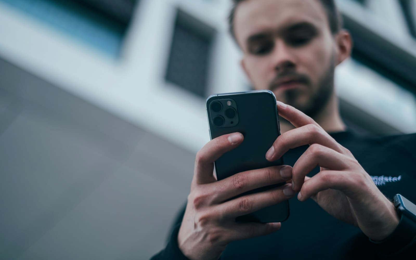 Engineer holding a smartphone to check mobile network signal