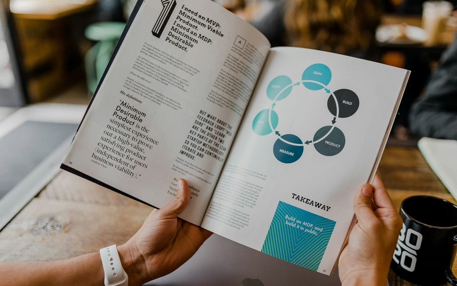 Designer arranging visual charts and graphic elements on a desk