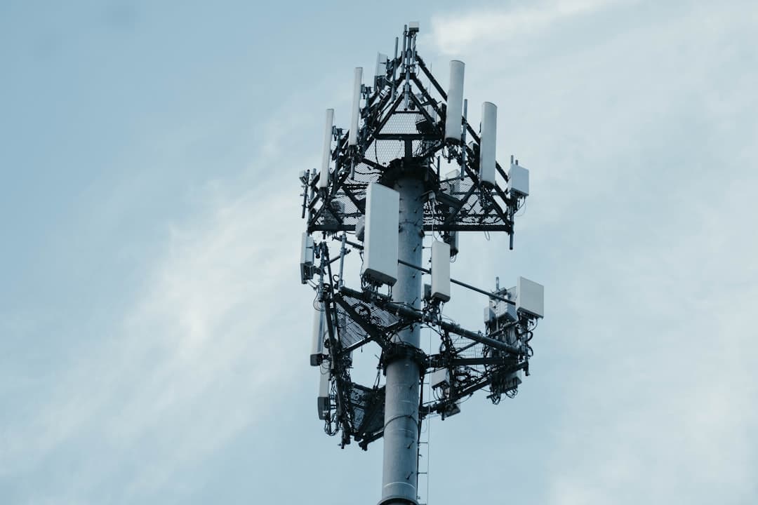 Mobile network antenna tower against a blue sky