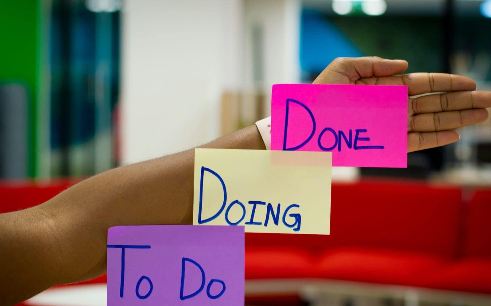 Sticky notes labelled To Do, Doing and Done on an arm for task tracking