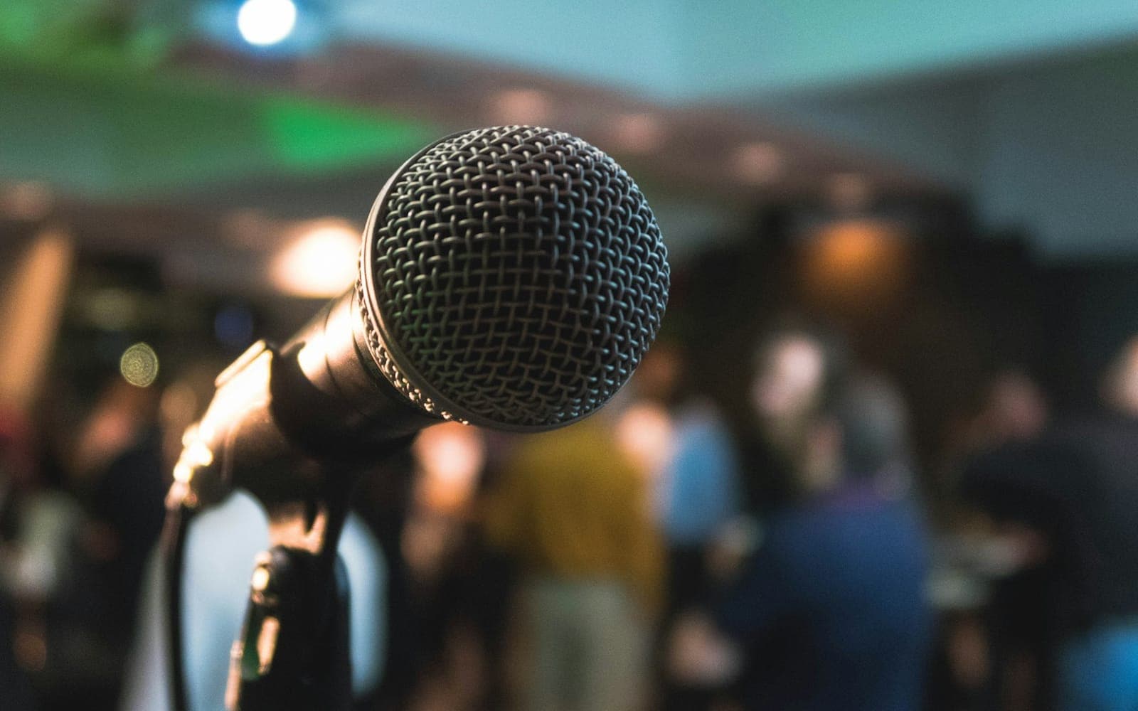 Speaker presenting on stage to an attentive audience