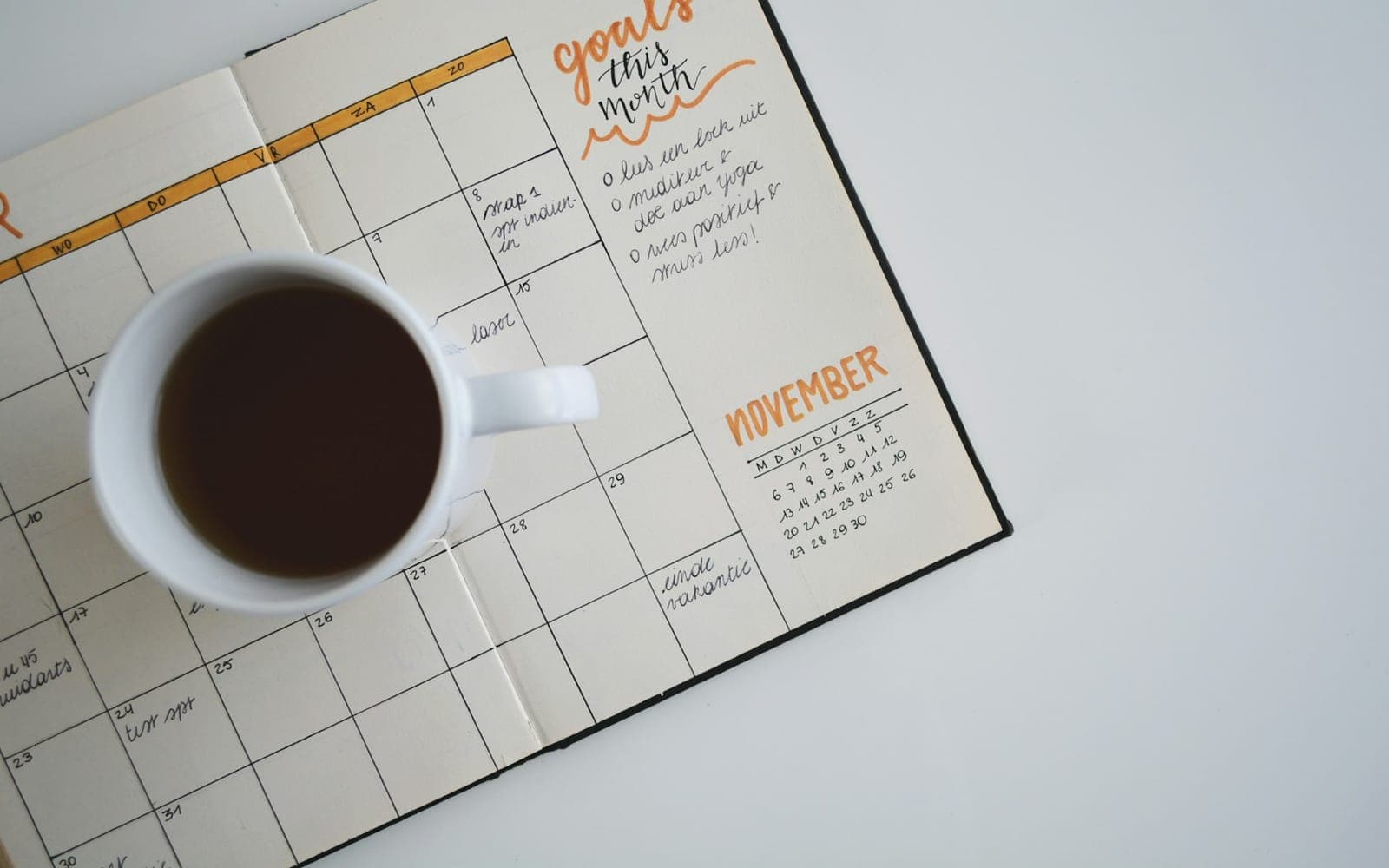 Open monthly planner and schedule notes representing project scheduling