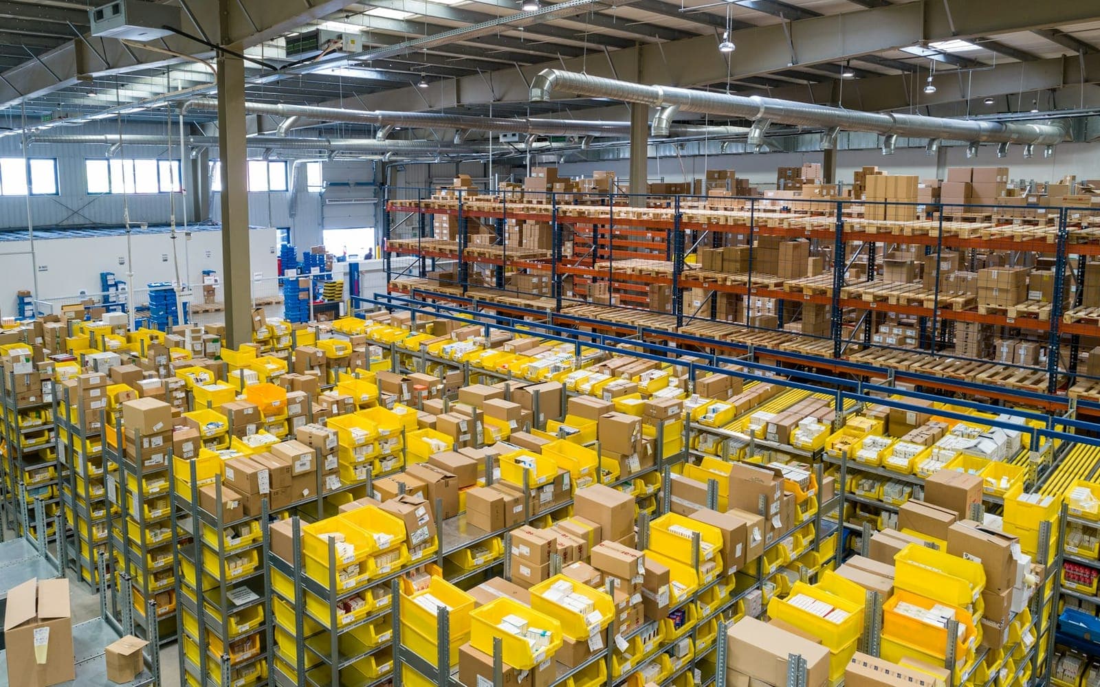 Warehouse aisles stacked with inventory on pallet racking