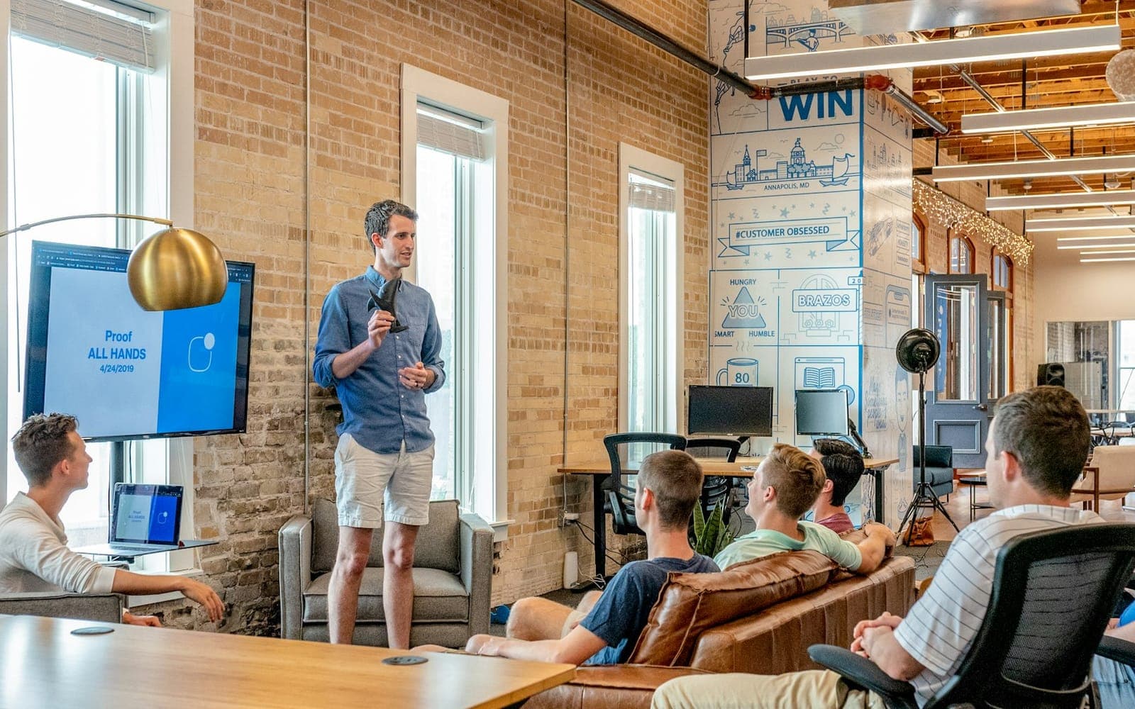 Sales presenter pointing to ideas on a whiteboard
