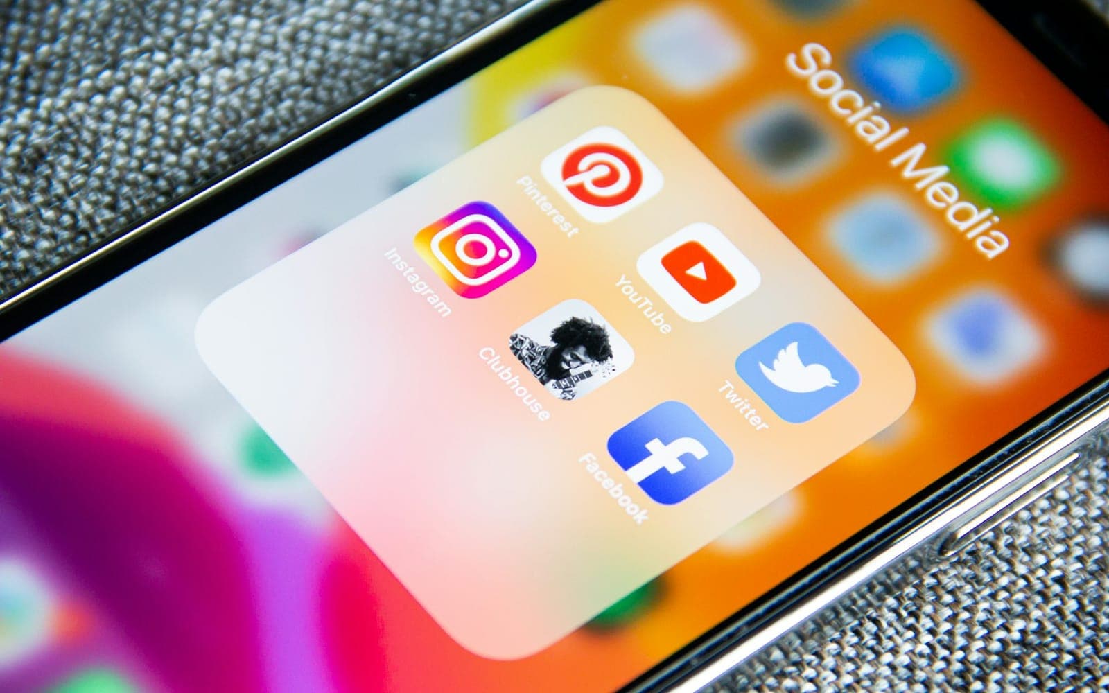 Smartphone social media app folder showing Instagram Facebook and YouTube icons