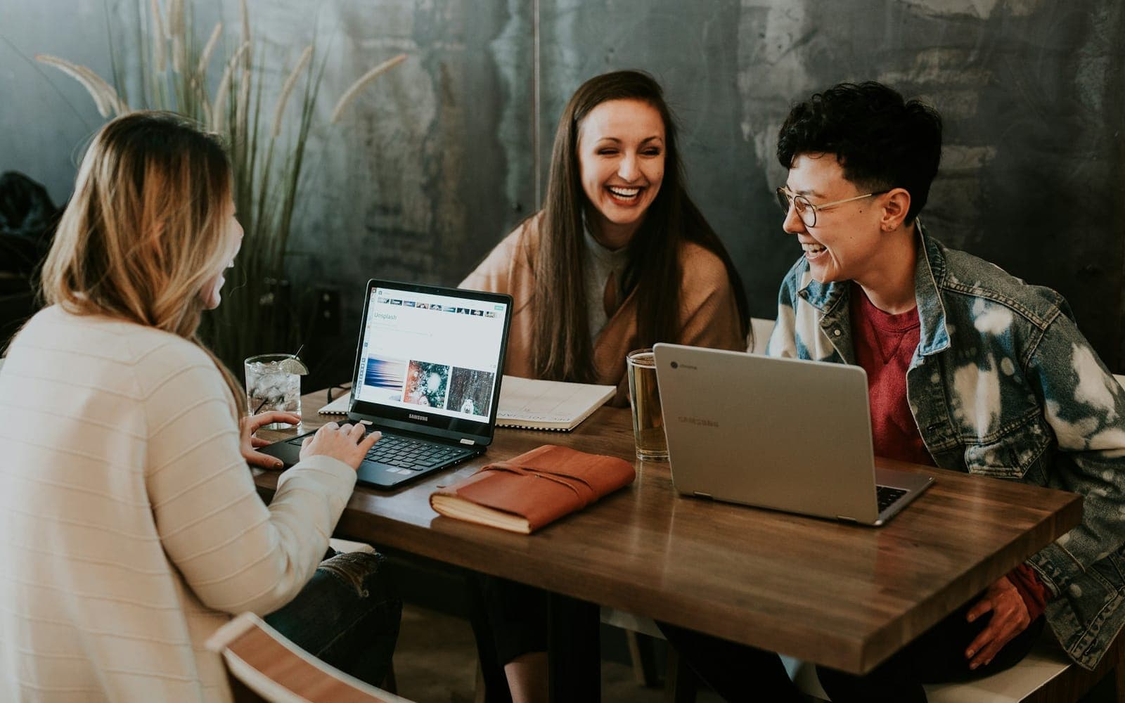 Adult learners collaborating with a trainer around a shared table