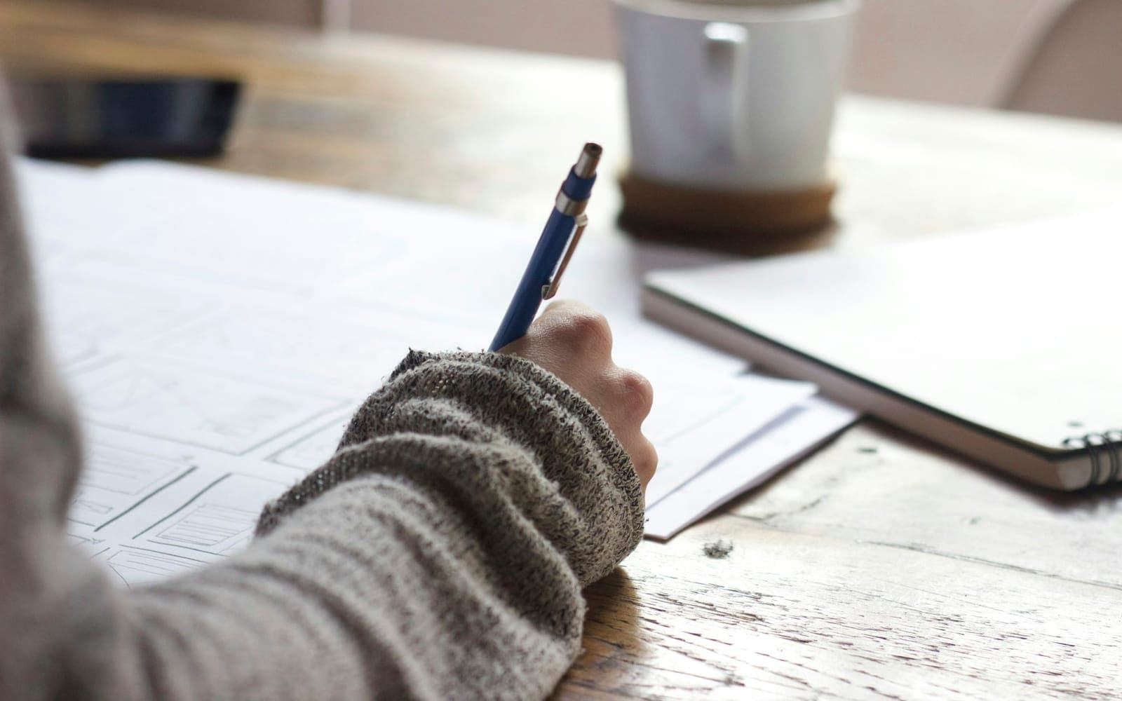 Clipboard notes and survey forms spread across a workplace desk